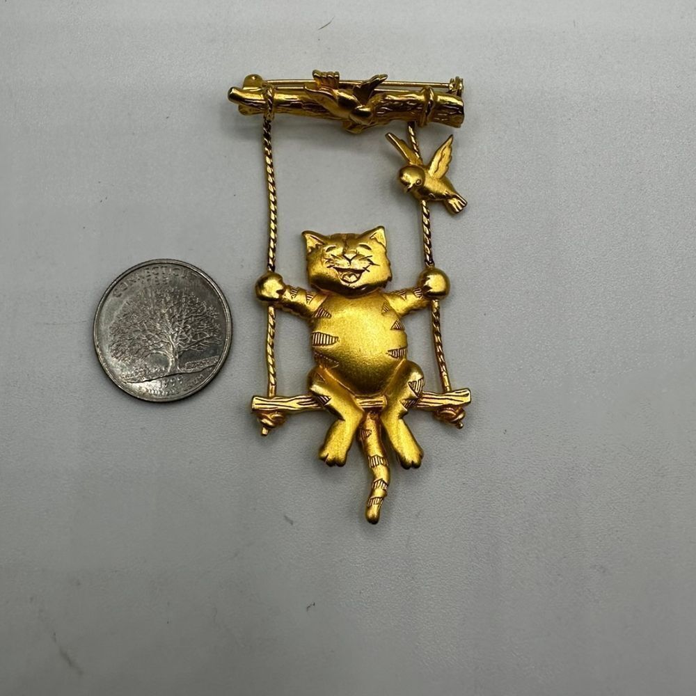 Vintage J.J. gold Cat on a swing brooche